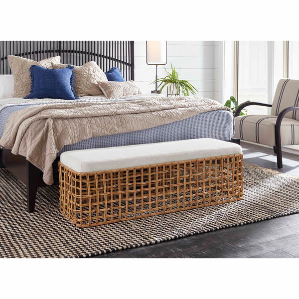 Wicker bench at the foot of a bed